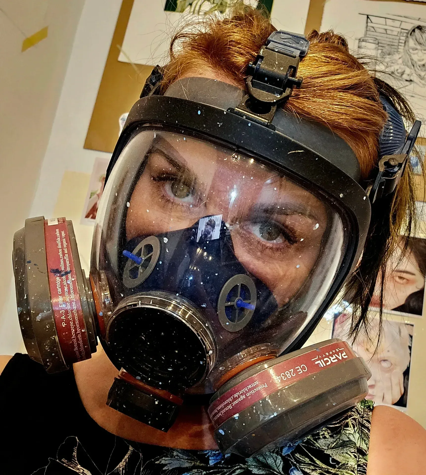 Pi Square exhibition view with artist wearing protective mask near a painting