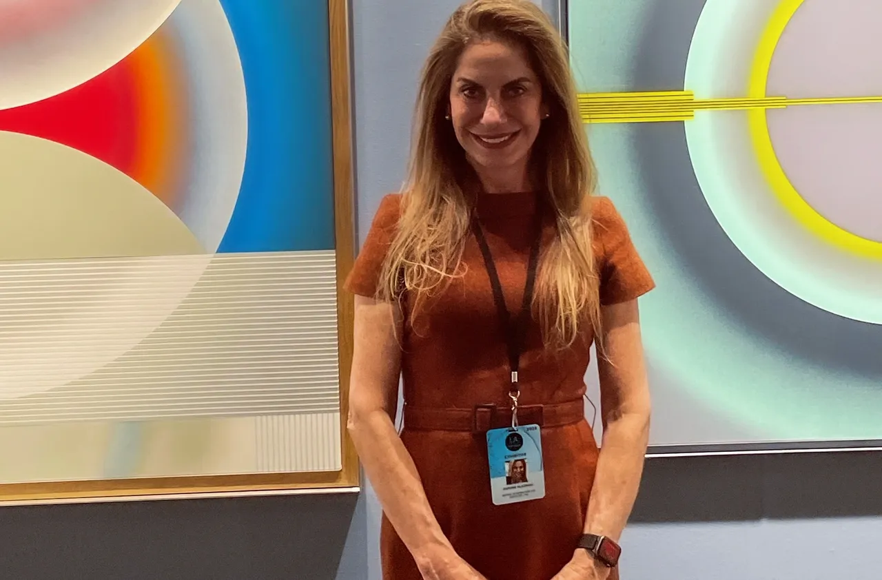 Daphne Alazraki Fine Art representative with Pi Square painting in an international gallery context